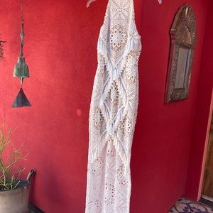 New, without tags. White crochet dress with tassels and nude liner.